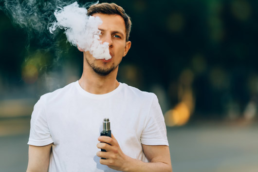 Persona fumando con vaper